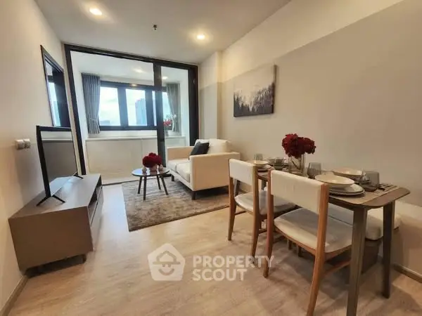 Modern living room with dining area and large windows in a stylish apartment.