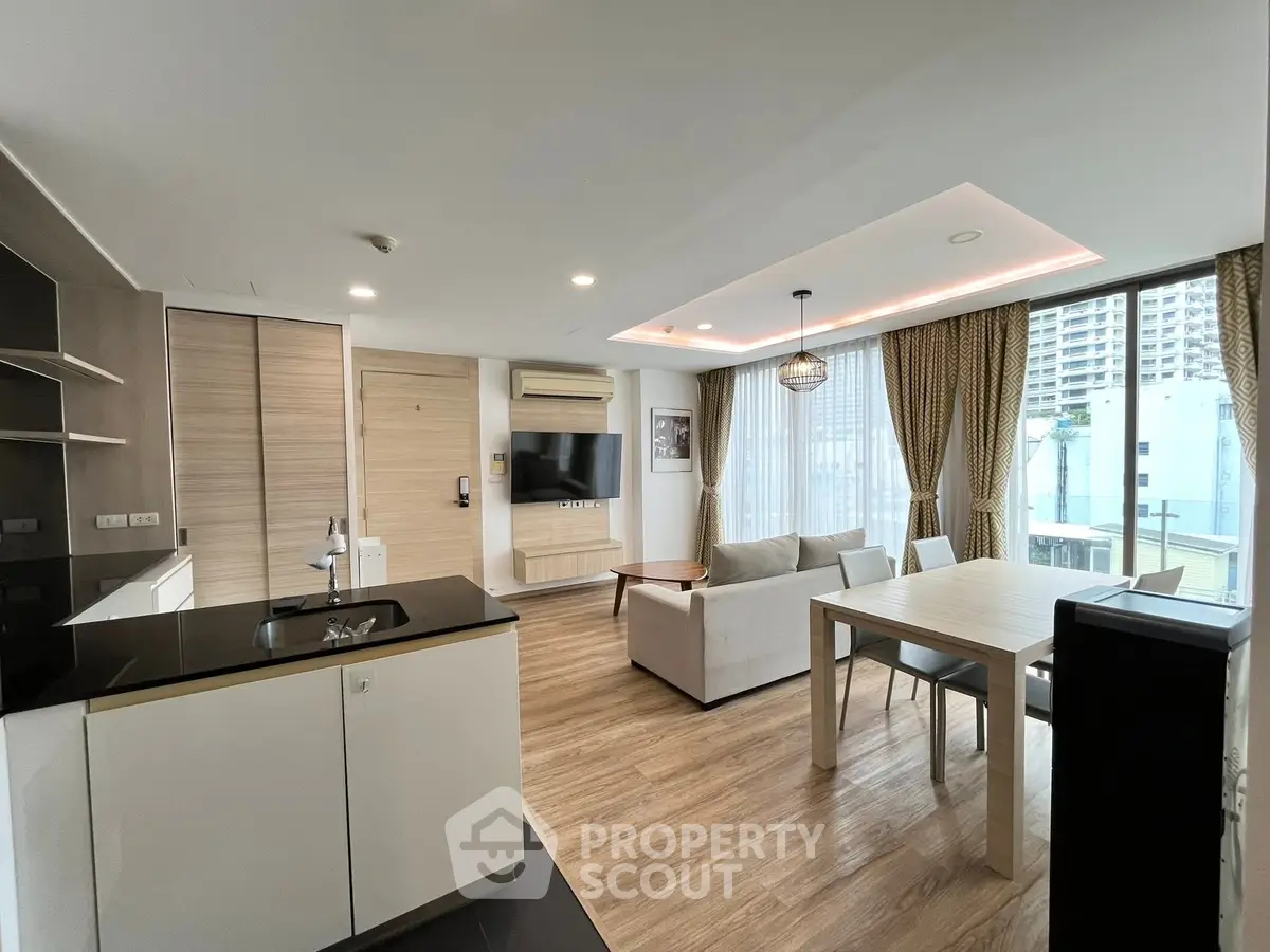 Modern open-plan living room with stylish kitchen and large windows