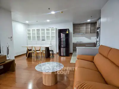 Modern open-plan living room with stylish kitchen and cozy seating area