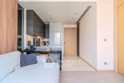 Modern open-layout kitchen and living area with sleek design and neutral tones.