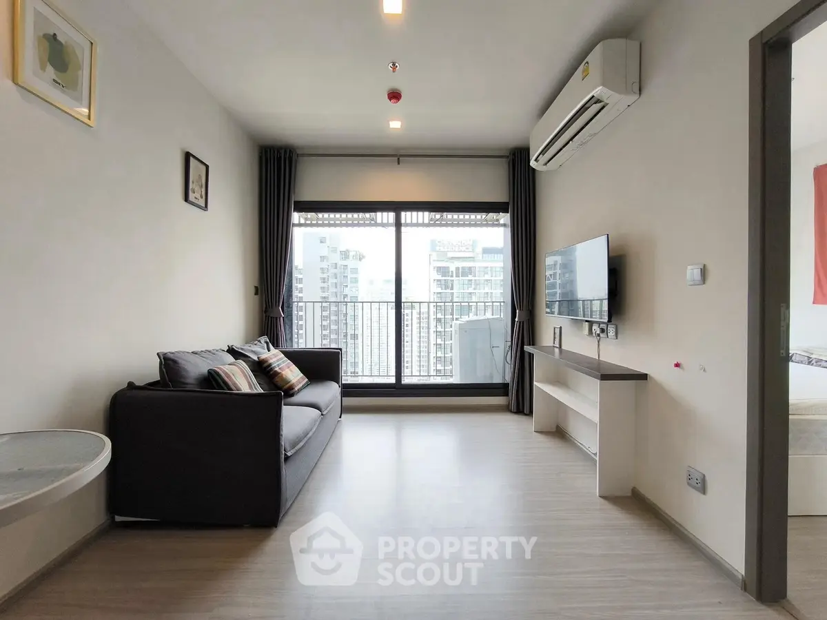Modern living room with city view and sleek furnishings