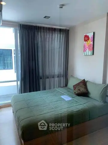 Cozy bedroom with modern decor and large window for natural light