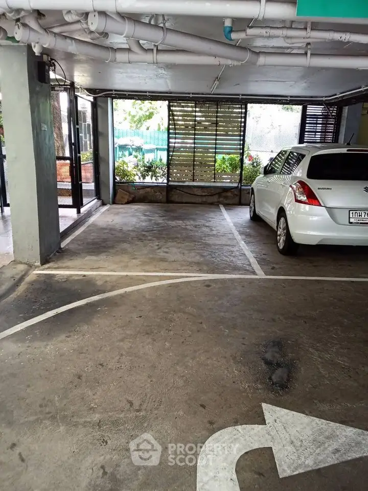 Spacious indoor parking area with natural light and secure environment.