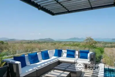 Luxurious outdoor seating area with stunning panoramic view and modern design.