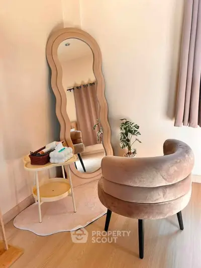 Stylish modern living room with unique wavy mirror and plush curved chair, perfect for contemporary interiors.