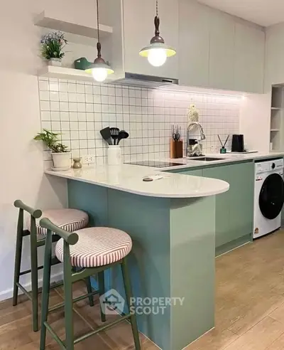 Modern kitchen with stylish bar stools and integrated appliances