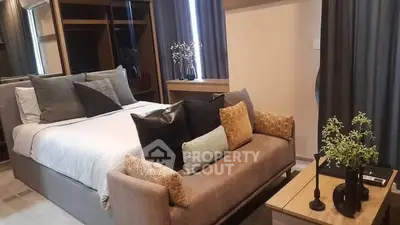 Luxurious bedroom with elegant decor and cozy seating area, perfect for relaxation.