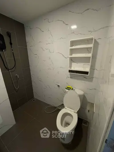 Modern bathroom with sleek design and wall-mounted shower