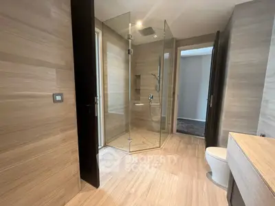 Luxurious modern bathroom with glass shower and elegant wood paneling