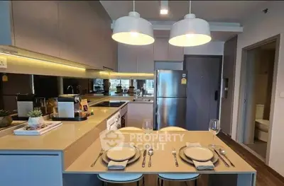 Modern kitchen with sleek design, featuring an open layout, stylish lighting, and contemporary appliances.