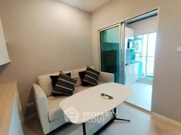 Modern living room with cozy sofa and sliding glass door to balcony