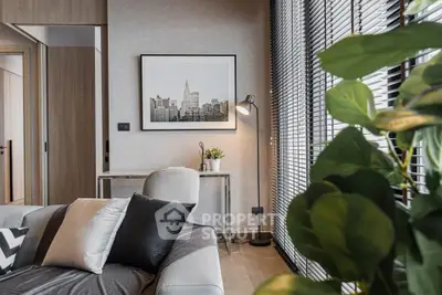 Chic modern living room with elegant gray sofa, stylish cushions, and a sleek floor lamp, complemented by a vibrant indoor plant and framed cityscape art.