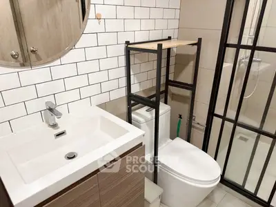 Modern bathroom with sleek fixtures and glass shower enclosure