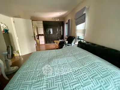 Spacious bedroom with modern decor and ample natural light