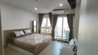 Spacious bedroom with balcony access in modern apartment