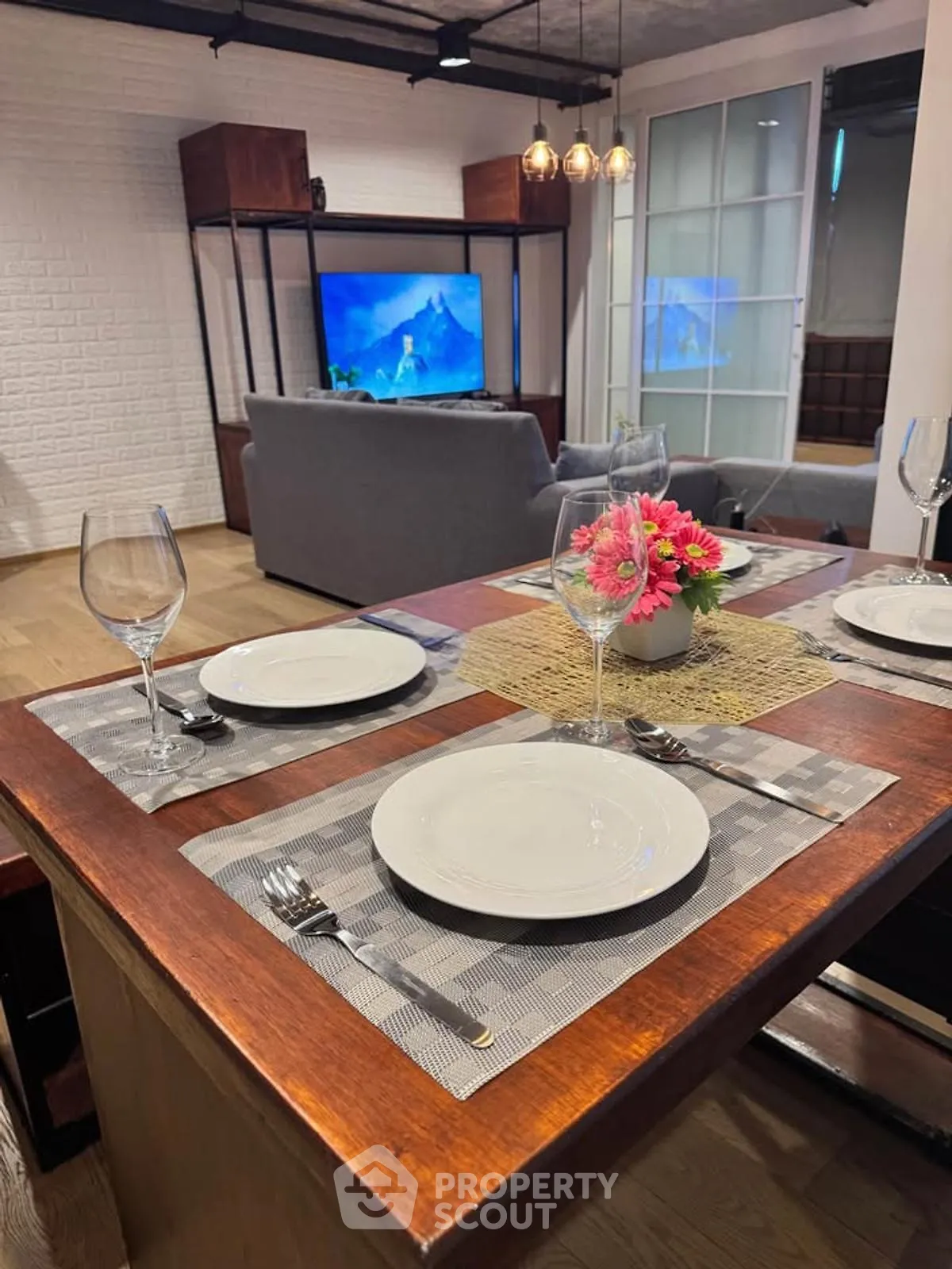 Stylish modern living room with dining area, featuring elegant decor and a cozy ambiance.