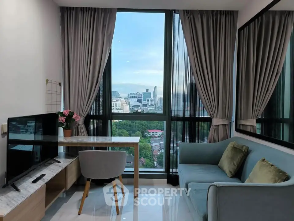 Modern living room with city view, stylish furniture, and floor-to-ceiling windows in a high-rise apartment.