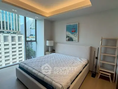 Modern bedroom with large window and city view in high-rise apartment