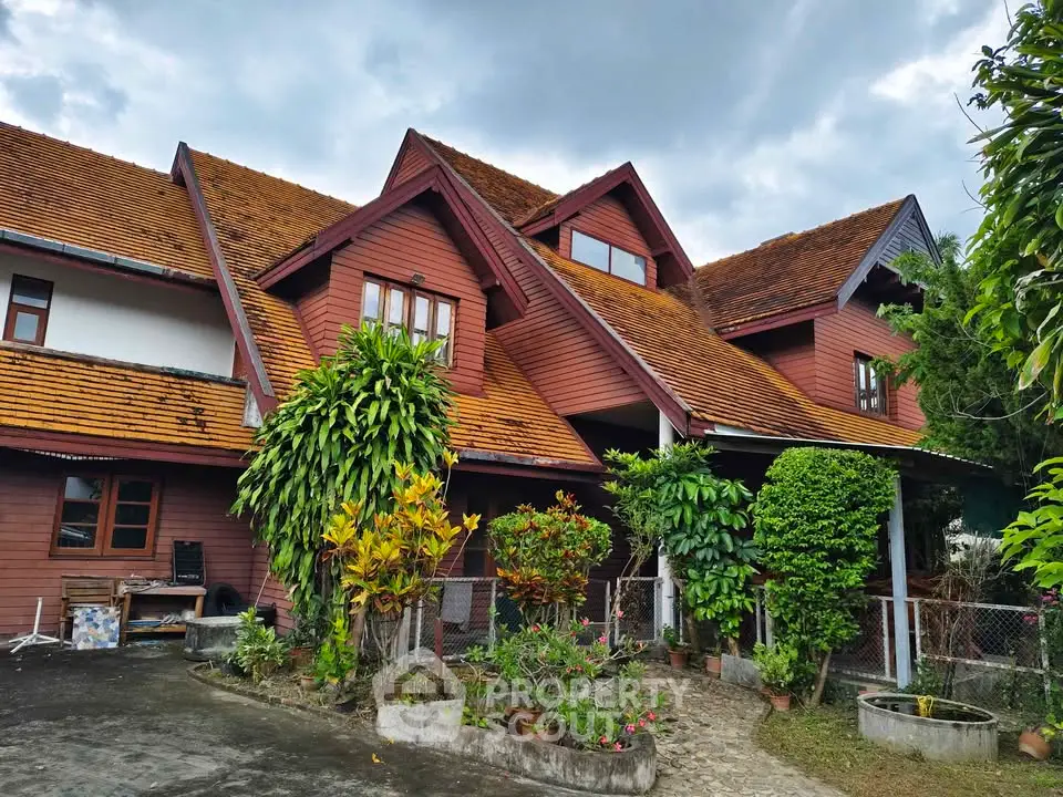Charming rustic house with lush garden and unique architectural design.
