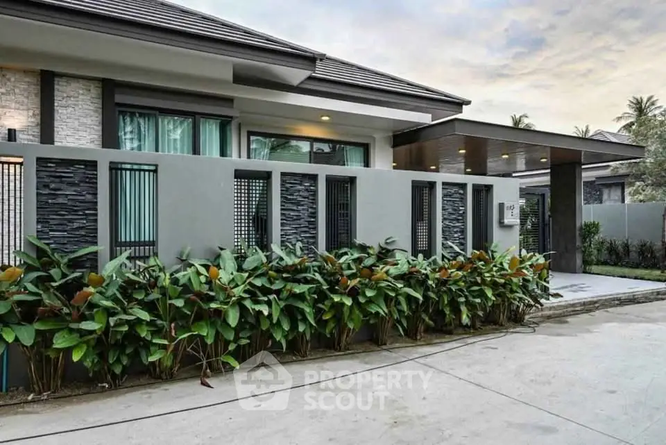 Modern luxury home exterior with sleek design and lush landscaping