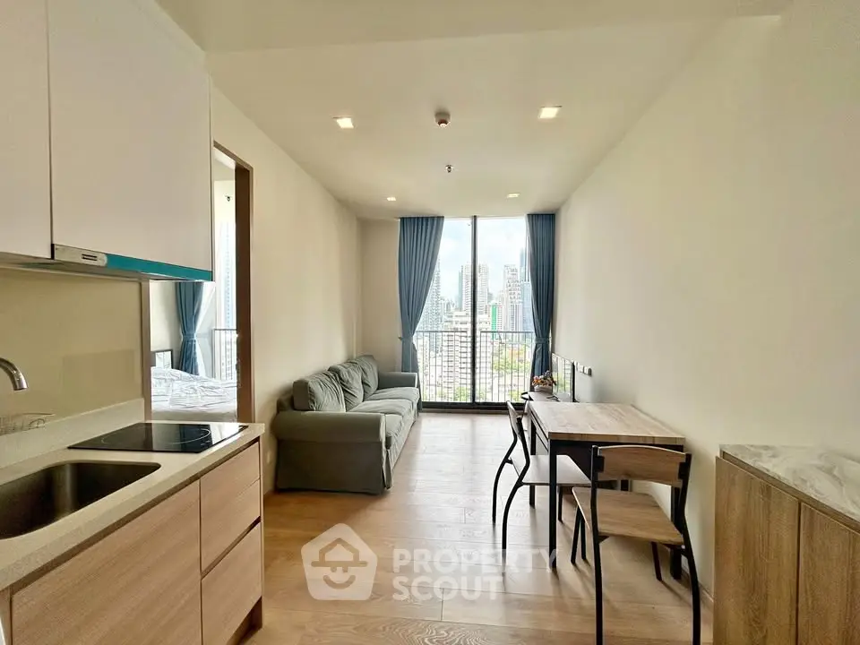 Modern living room with city view, featuring sleek furniture and open layout.