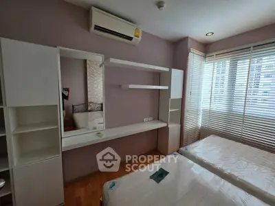 Modern bedroom with air conditioning and large windows in a stylish apartment.