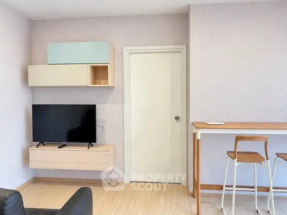 Modern living room with mounted TV and minimalist decor