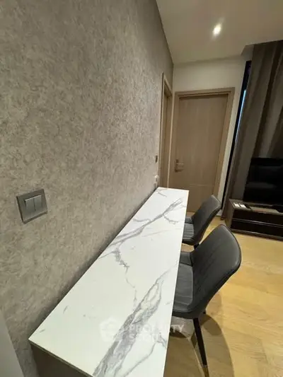 Modern study area with marble desk and stylish chairs in a contemporary home.