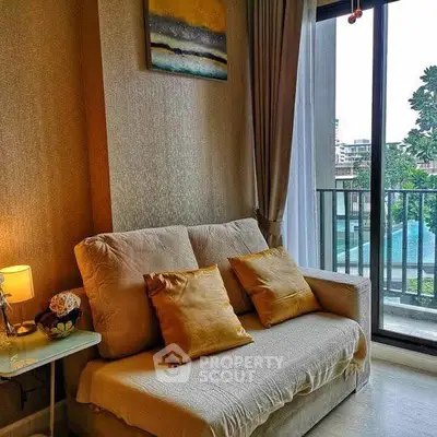 Cozy living room with plush sofa and balcony view in modern apartment