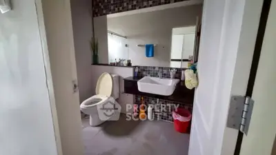 Modern bathroom with stylish sink and tiled backsplash