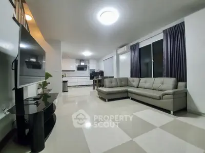 Spacious modern living room with open kitchen and sleek furniture