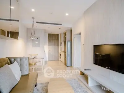 Modern living room with stylish decor and open layout, featuring a cozy seating area and sleek entertainment setup.