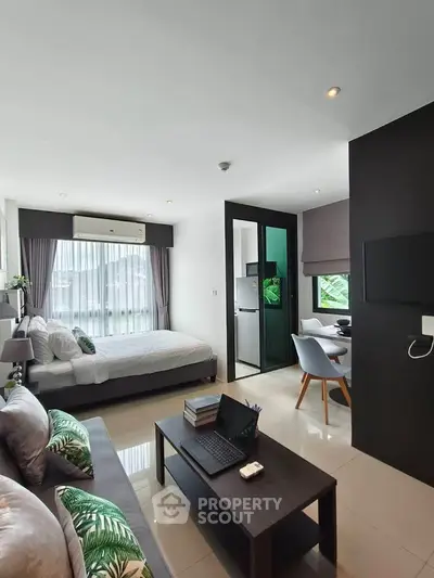 Modern studio apartment with open layout, featuring a cozy living area, stylish bedroom, and compact kitchen.