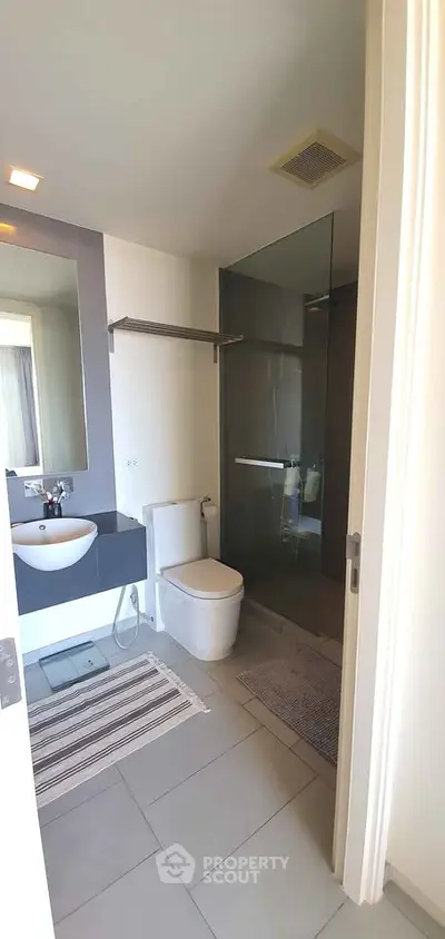 Modern bathroom with sleek fixtures and glass shower enclosure