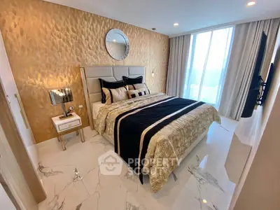 Luxurious bedroom with elegant decor and large windows offering natural light.