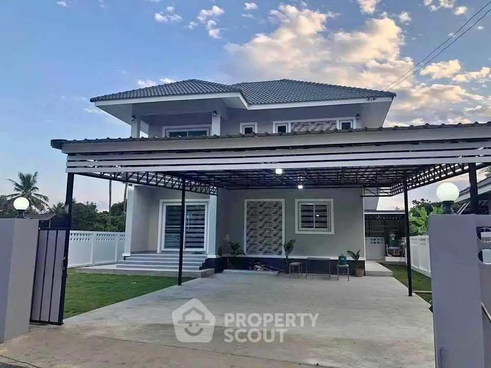 Modern two-story house with spacious driveway and lush green lawn