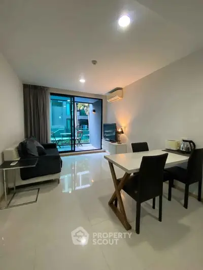 Modern living room with dining area and balcony view in stylish apartment