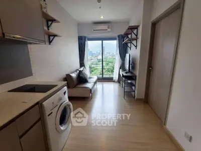 Modern apartment living room with city view, featuring sleek furniture and built-in appliances.
