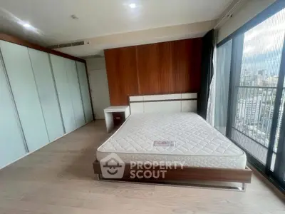 Spacious bedroom with city view and modern design in high-rise apartment