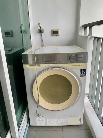 Spacious balcony with modern washing machine, perfect for convenient laundry in your home.