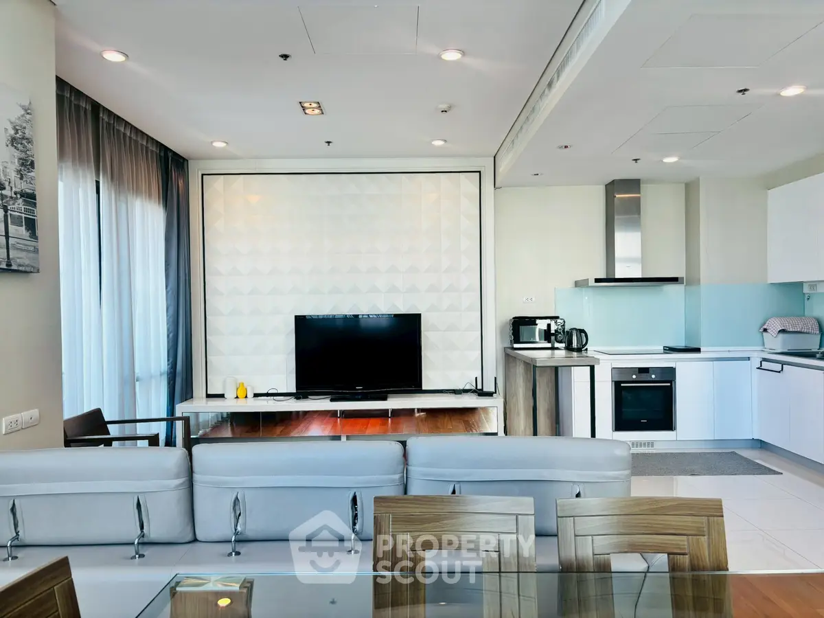 Modern open-plan living room with sleek kitchen and stylish decor