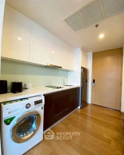 Modern kitchen with sleek cabinetry and built-in appliances in a stylish apartment.