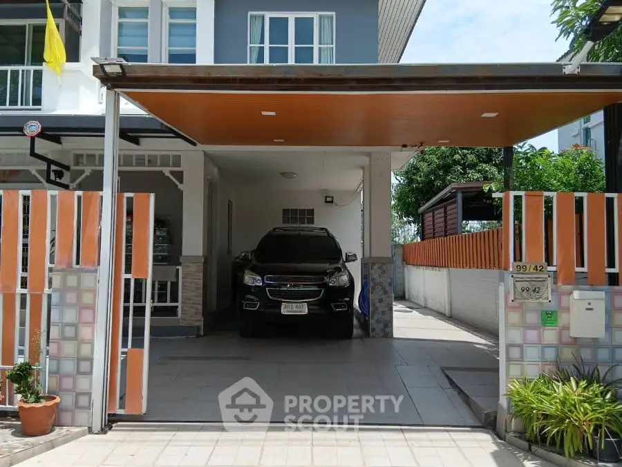 Modern townhouse with covered parking and gated entrance in sunny neighborhood.