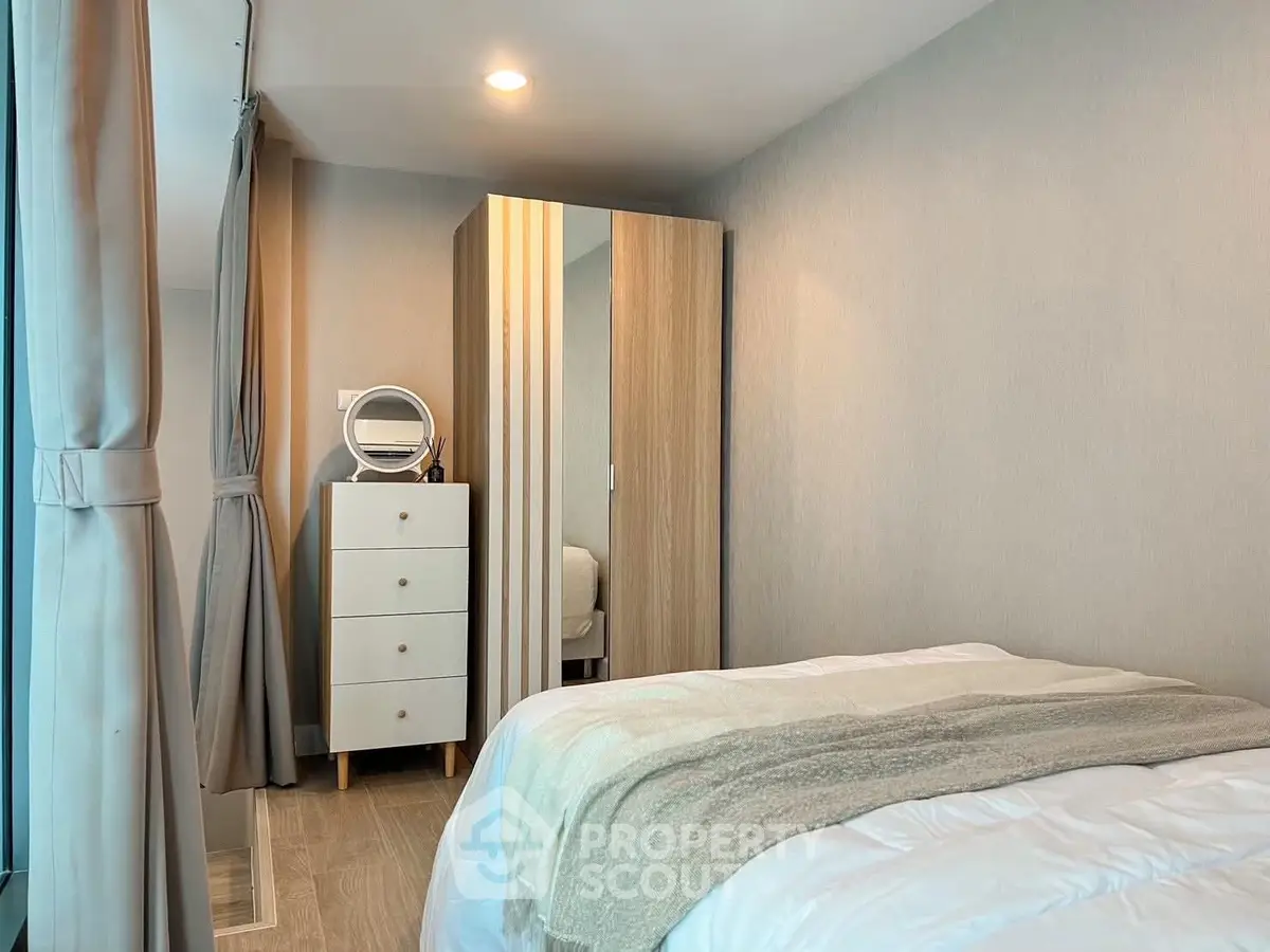 Cozy bedroom with modern decor and ample natural light