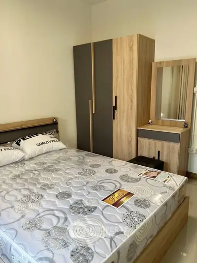 Cozy bedroom with modern wooden furniture and comfortable mattress, perfect for restful nights.