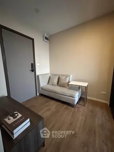 Cozy living room with modern sofa and wooden flooring in a stylish apartment.