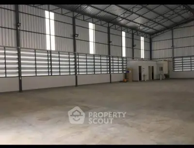 Spacious industrial warehouse with high ceilings and ample natural light