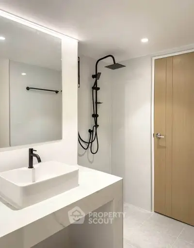 Modern minimalist bathroom with sleek fixtures and elegant design.