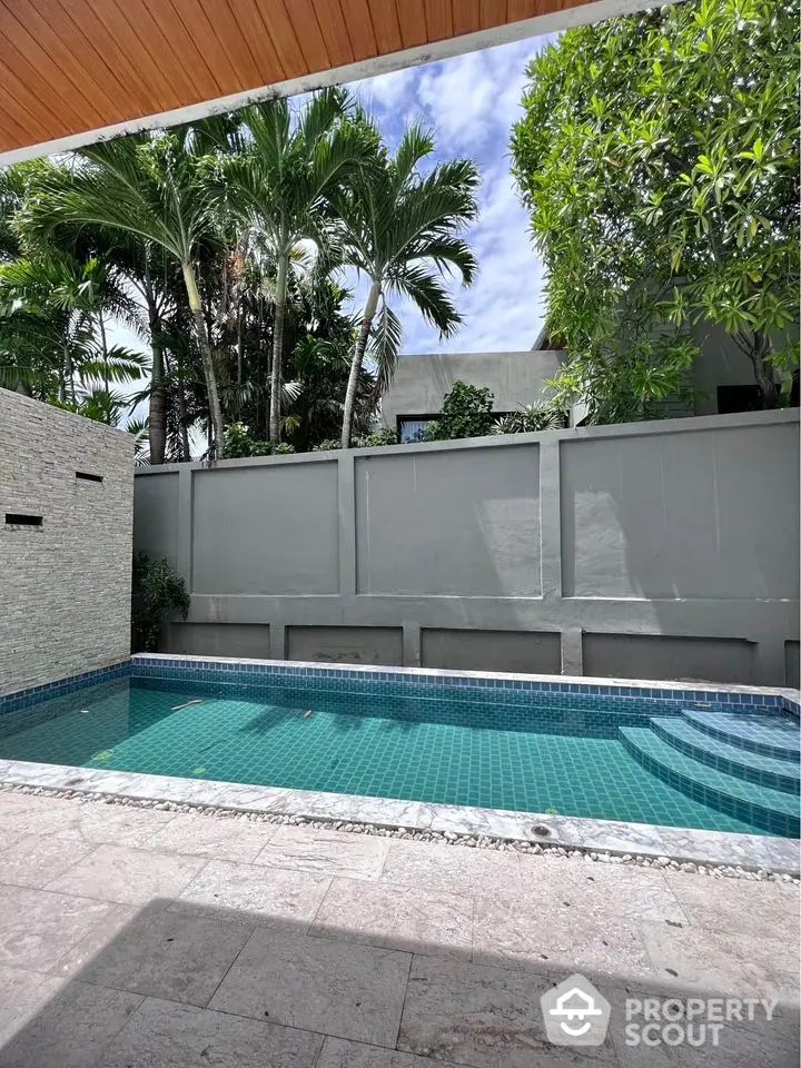 Luxurious private pool with lush greenery and modern design