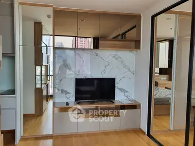 Modern living room with sleek TV unit and mirrored cabinets
